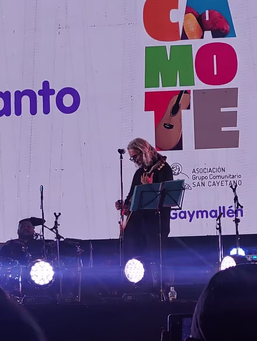 Ruben Tapia tocando la guitarra sobre el escenario.